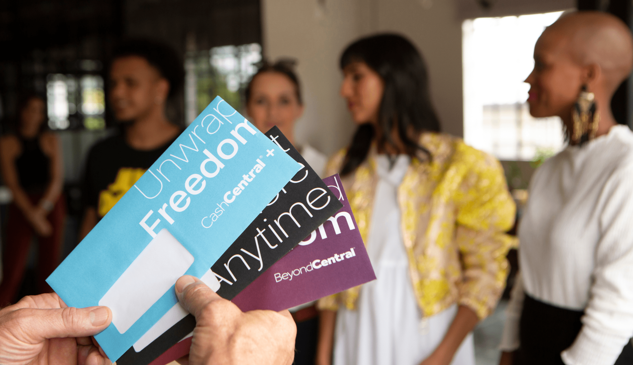 Employee gifting Hand holding PayCentral card envelopes to present employees with gift cards